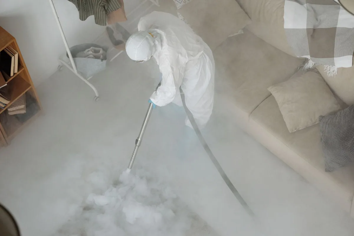 Biohazard cleanup technician in protective equipment, Bono, AR